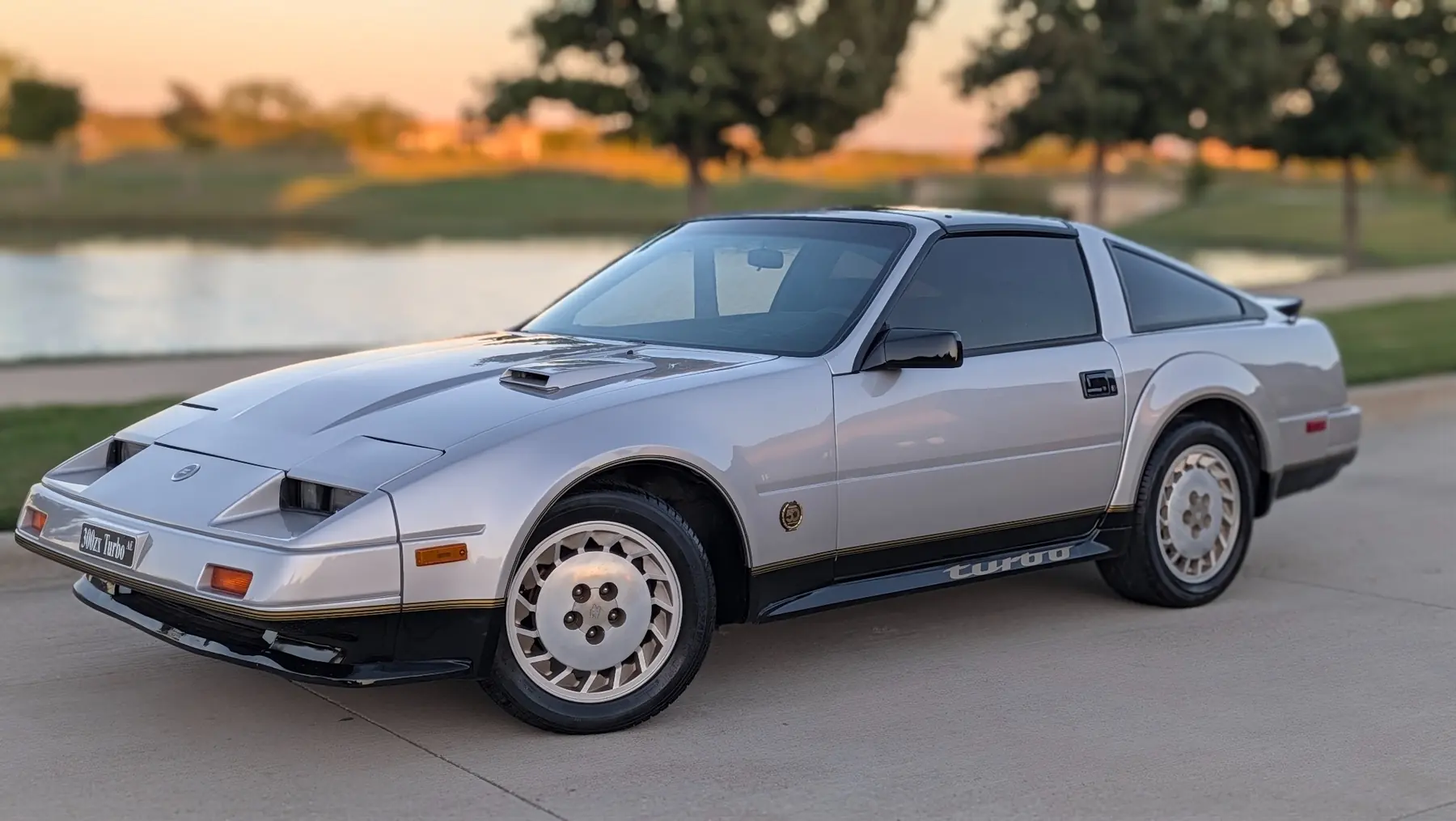 Silver Nissan 300ZX Turbo Anniversary Edition beside a lake